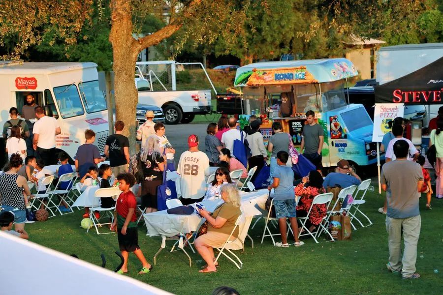 Golden evening light over the food trucks and crowd at Family Fun Fest